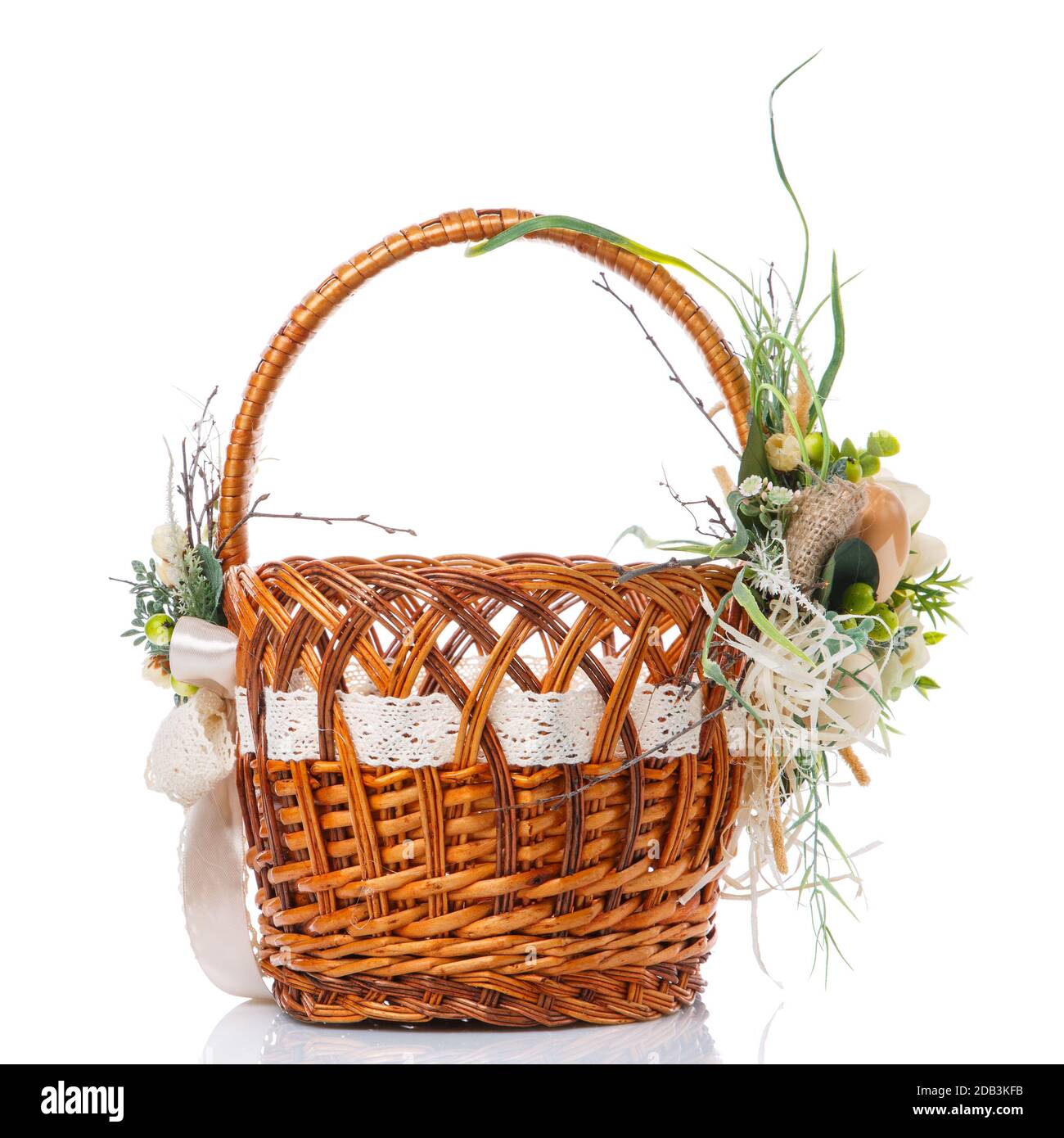 Brown wicker basket with floral decor and ribbons on white background ...