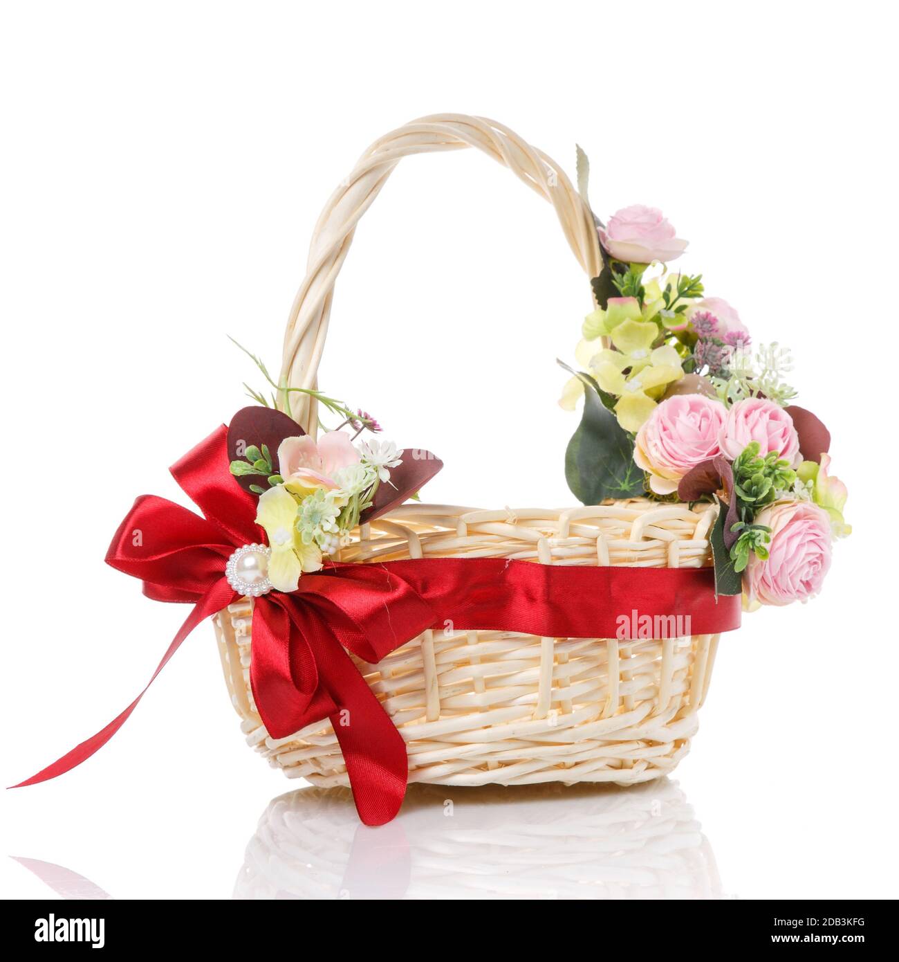 Pink flowers wicker basket decorated with beautiful red ribbon bow on ...