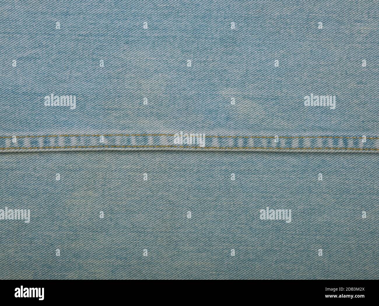 Light blue washed cotton jeans denim texture background with stitching ...