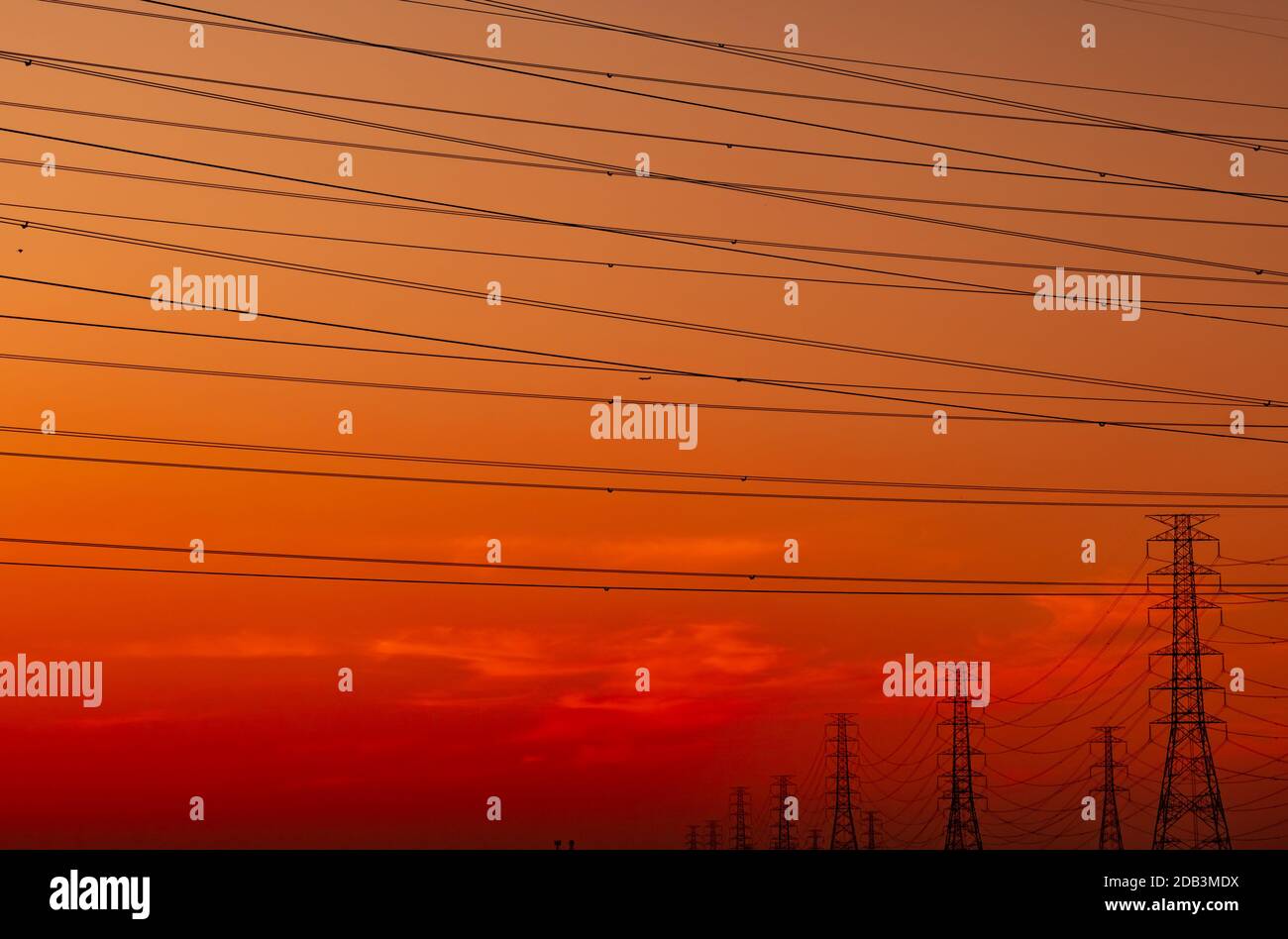 High voltage electric pylon and electrical wire with sunset sky ...
