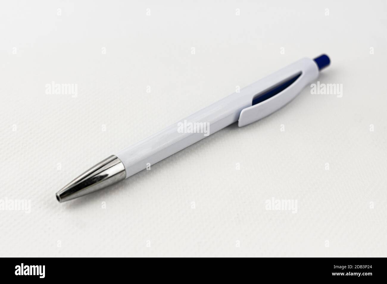 A blue and white pen with silver tip on white background Stock Photo ...
