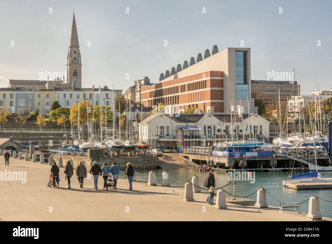 Walking the East Pier on a sunny day with a view of Dun Laoghaire seafront in County Dublin, Ireland Stock Photo