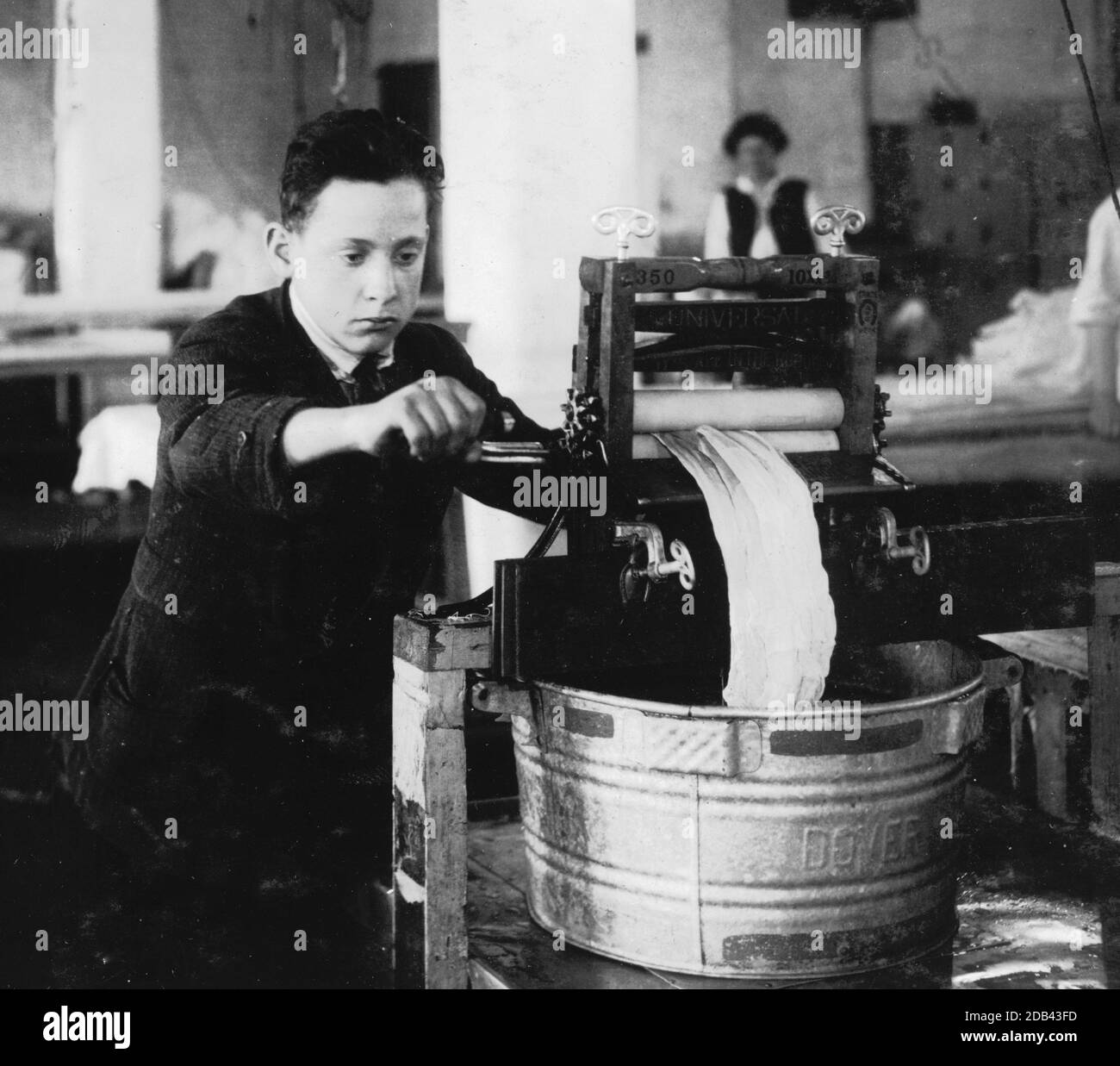 Edward McGurin, 14 years old. Wringing curtains at Boutwell, Fairclough & Gold, 274 Summer Street Extension.. Stock Photo