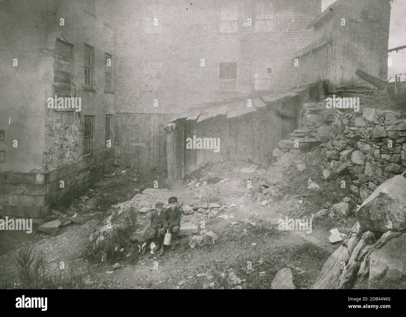 Two children sit in the rear of The Stone House, Hill Street, Central Falls, R.I. Stock Photo