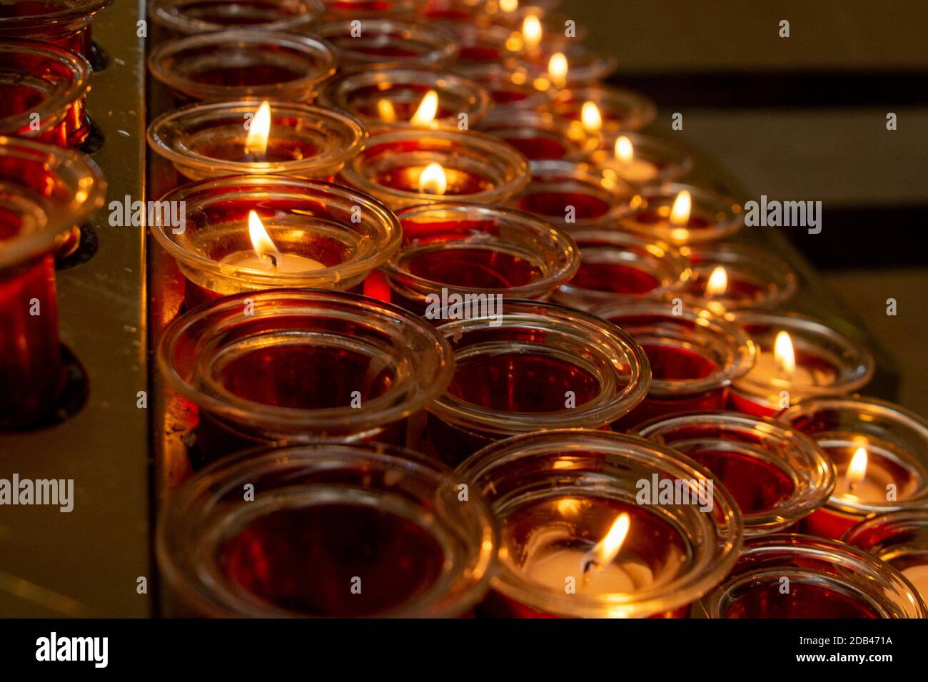 A bank of lighted candles in a church Stock Photo