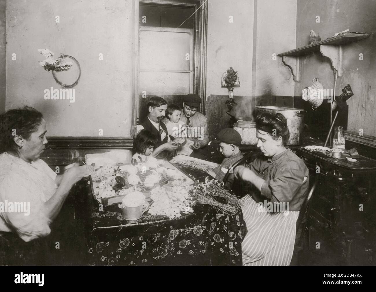 4 P.M. John Sachatello, a barber with a steady job helping family make flowers, 302 Mott St. Making 'bluettes' at $2.00 a gross. Makes $12.00 to $13.00 a week when all work. Mary 5 yrs. old. Tommy 7 yrs. old.. Stock Photo