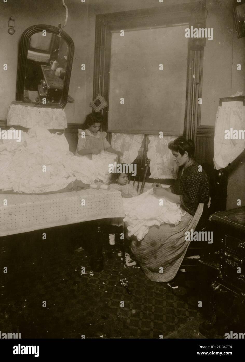 Rose Vetrano, 9 yrs. old, helping her mother on corset-covers, 71 Sullivan St., 3rd floor back.. Stock Photo