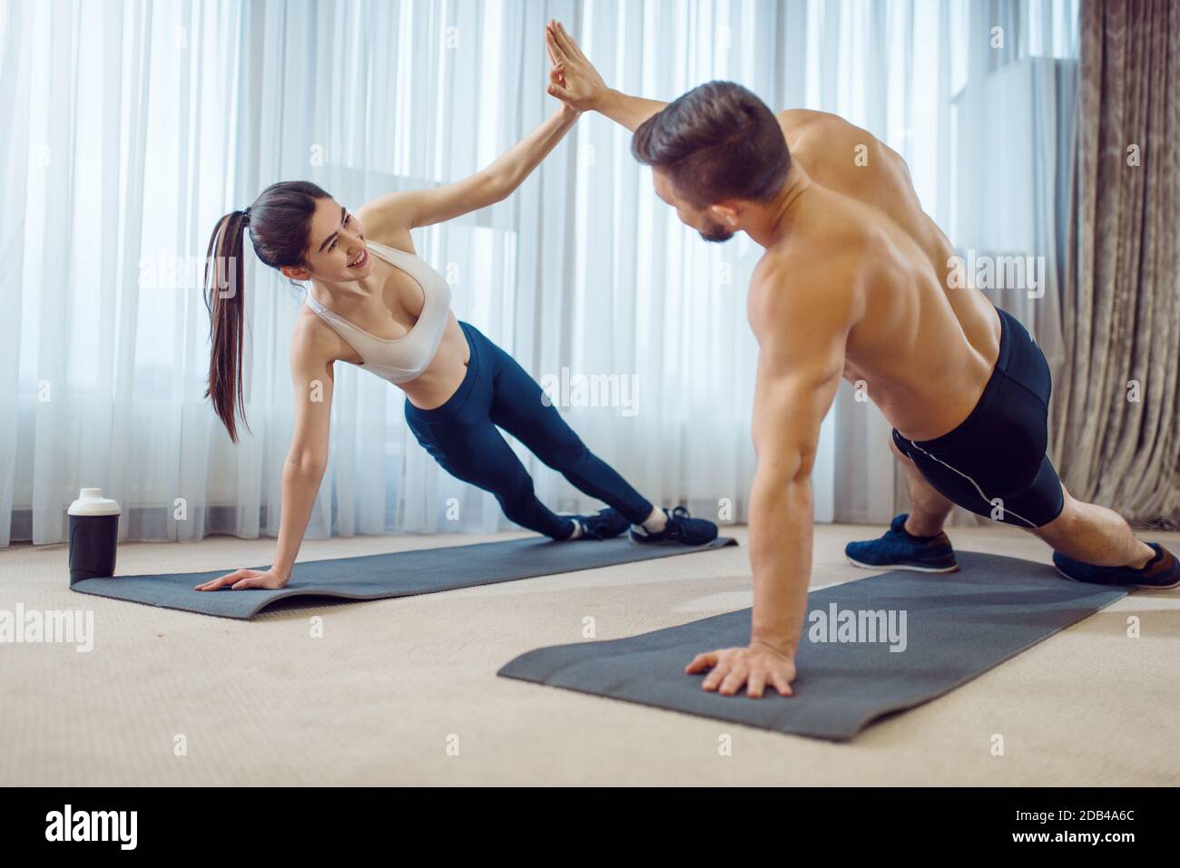 Morning fit workout of love couple at home. Active man and woman in sportswear doing push up exercise in their house healthy lifestyle physical cult Stock Photo Alamy