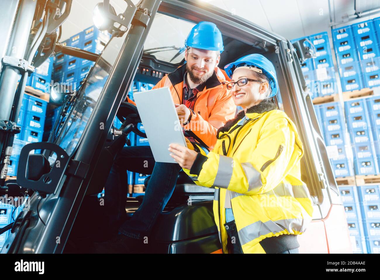 Team in beverage logistics on deployment briefing looking at tablet computer Stock Photo