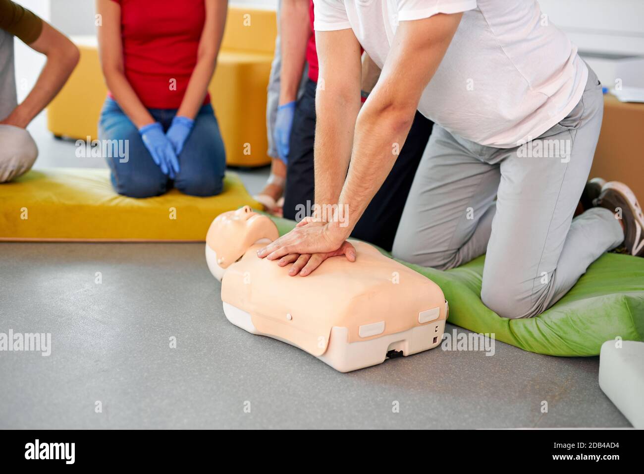 caucasian people practice an exercise of resuscitation during lesson, help injured people, first aid and medicine concept Stock Photo