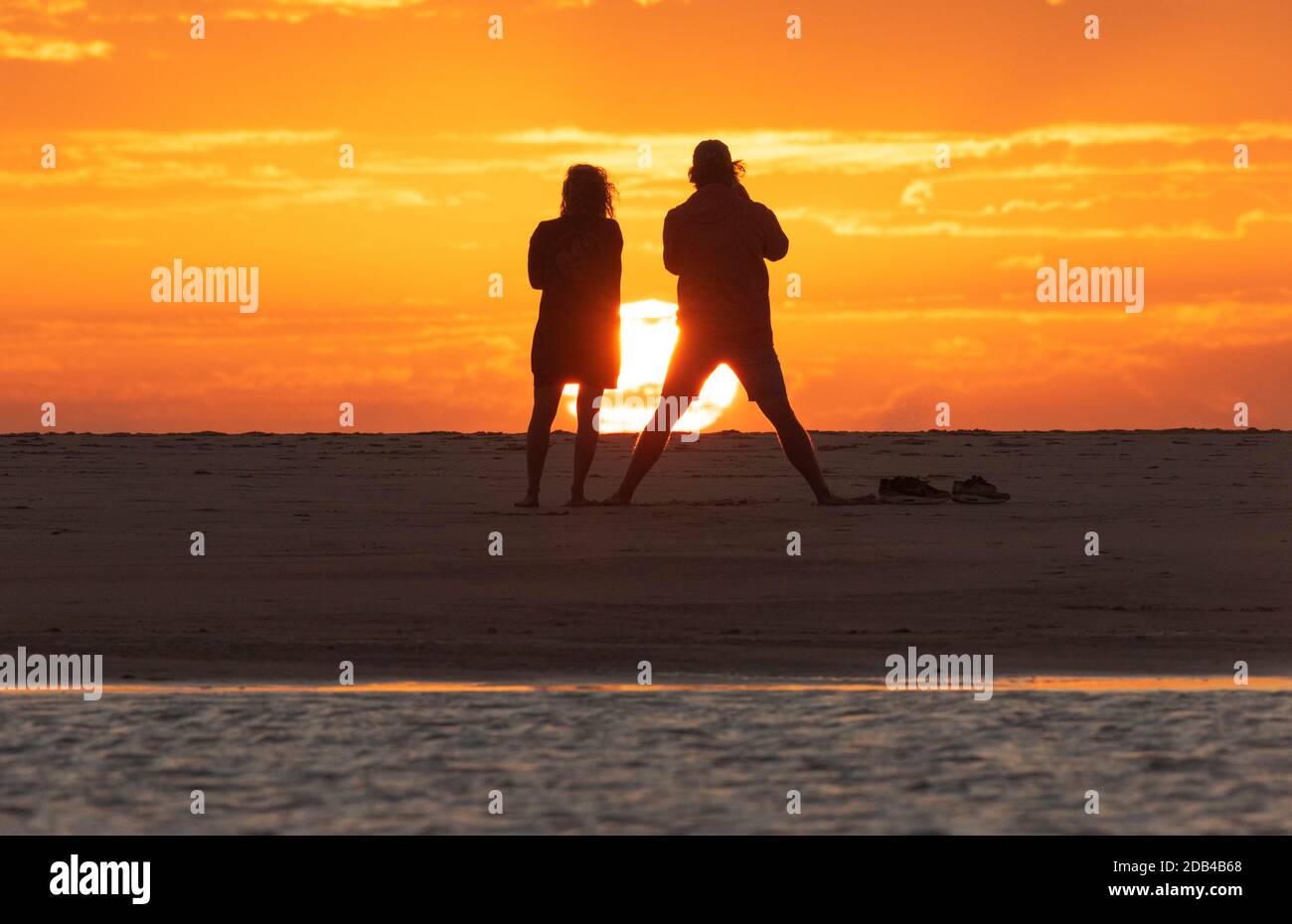 Couple looking at a sunset at Los Lances beach, Tarifa, Costa de la Luz, Cadiz, Andalusia, Spain Stock Photo