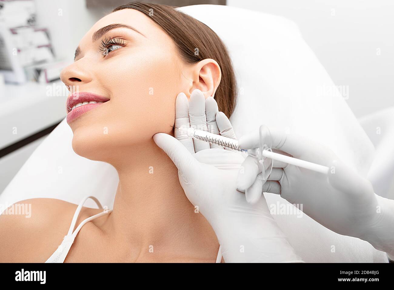 Woman during rejuvenation injections hi-res stock photography and ...