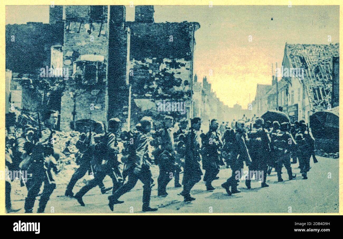 German troops marched trhrough destroyed village in France. Nazi Germany invaded in France in 1940. Stock Photo