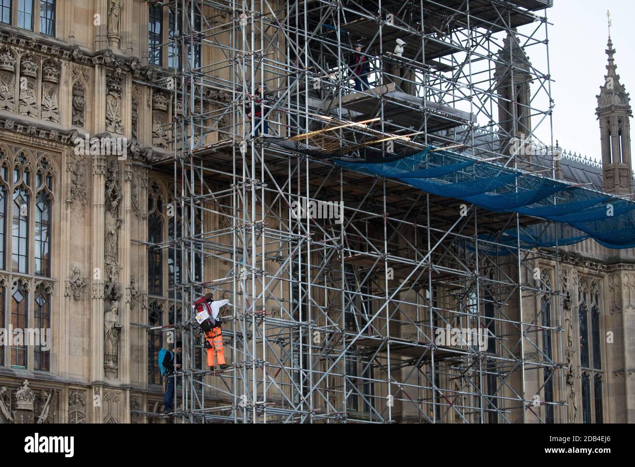 London, UK. 12th November, 2020. Activists from the group Action for Climate Truth and Reparations (ACTR) climb scaffolding to hang an open letter to the UK people from Africans Rising For Justice, Peace and Dignity from the Houses of Parliament. The letter, which launches Africans Rising’s ReRight History campaign, contains a plea to the UK people to start making amends for the harm caused by slavery and colonialism. Credit: Mark Kerrison/Alamy Live News Stock Photo