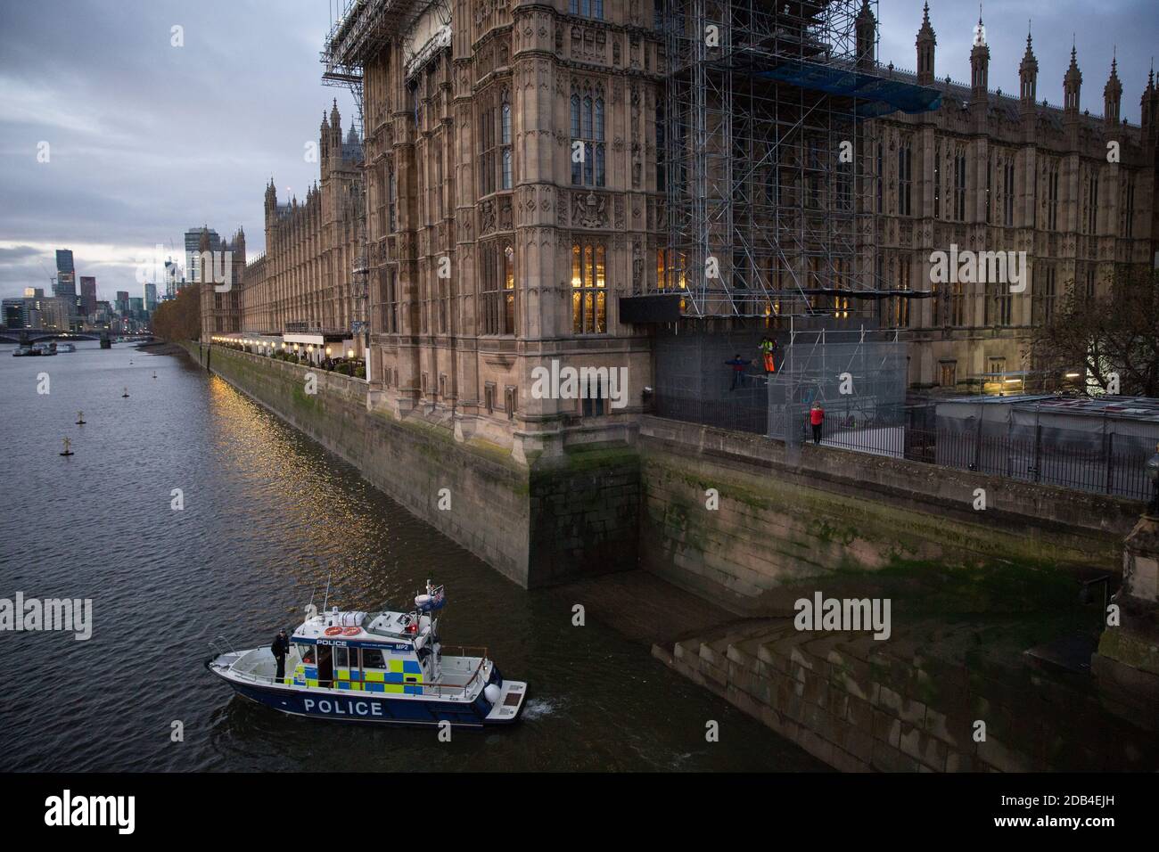 London, UK. 12th November, 2020. Activists from the group Action for Climate Truth and Reparations (ACTR) climb scaffolding at dawn to hang an open letter to the UK people from Africans Rising For Justice, Peace and Dignity from the Houses of Parliament. The letter, which launches Africans Rising’s ReRight History campaign, contains a plea to the UK people to start making amends for the harm caused by slavery and colonialism. Credit: Mark Kerrison/Alamy Live News Stock Photo