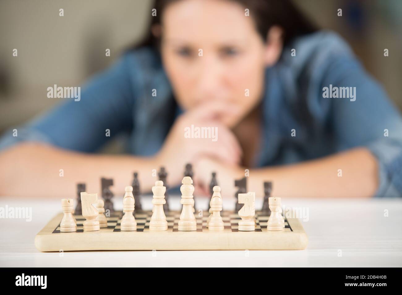 woman studying the next chess move Stock Photo - Alamy