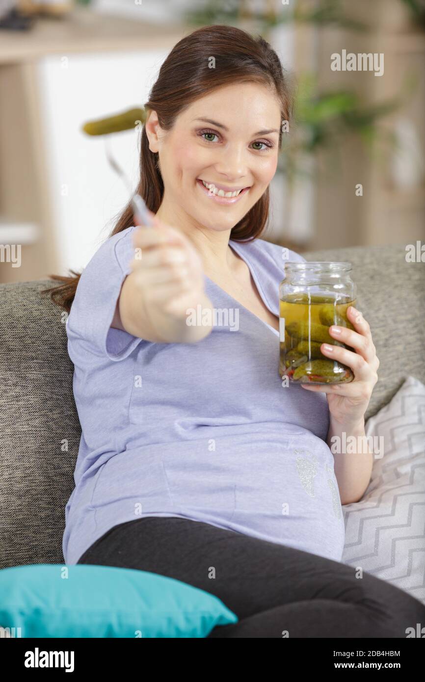 pregnant woman with cucumber sour and candy Stock Photo Alamy