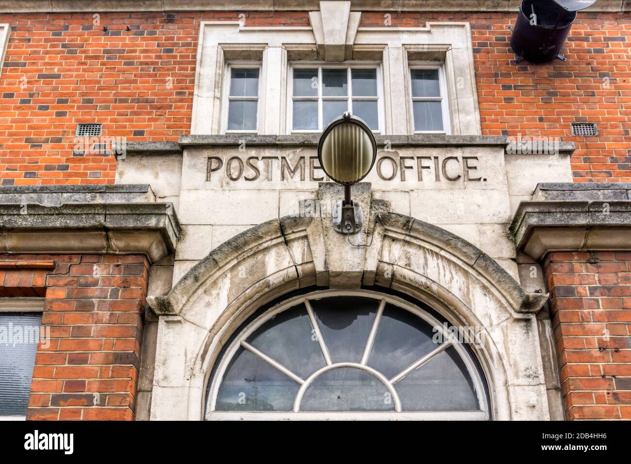 Postmen's Office carved over the entrance to Royal Mail Delivery Office in Wandsworth Road, south London. Stock Photo