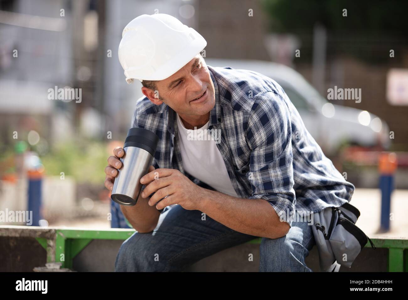 builder drinking coffee and resting Stock Photo