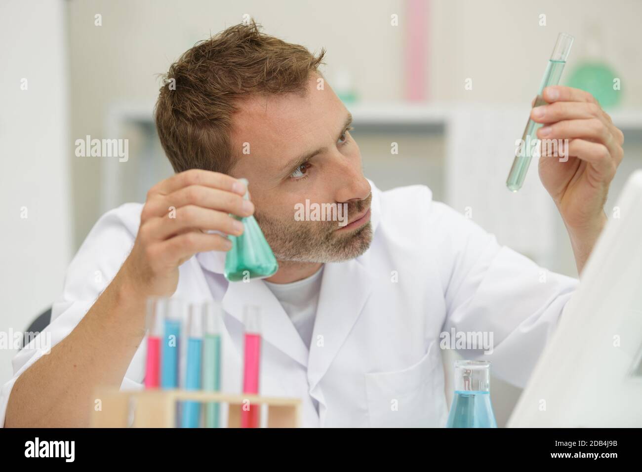 young male scientist doing experiments in laboratory Stock Photo