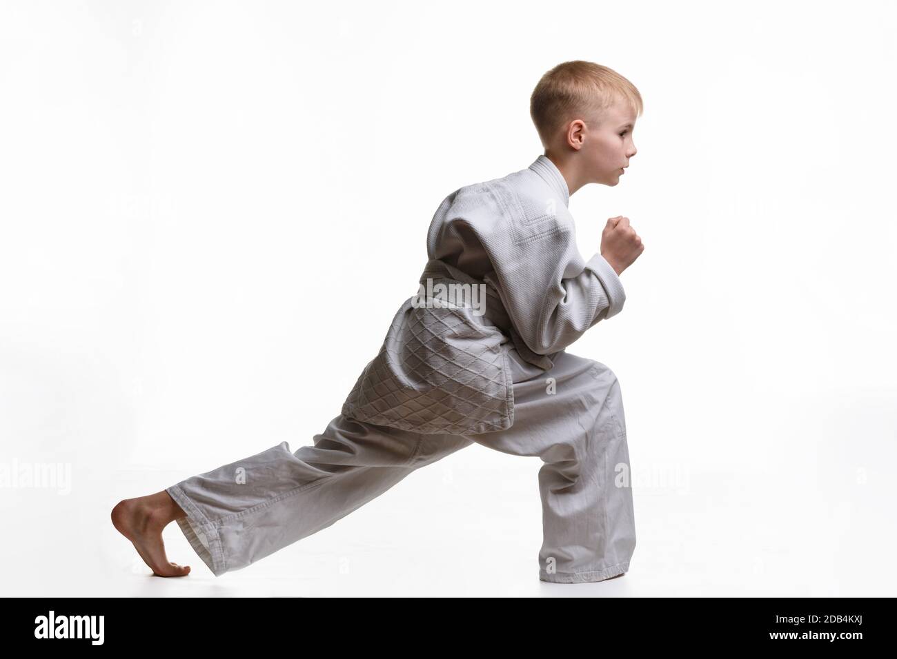 Martial arts student crouches and stretches his legs Stock Photo Alamy