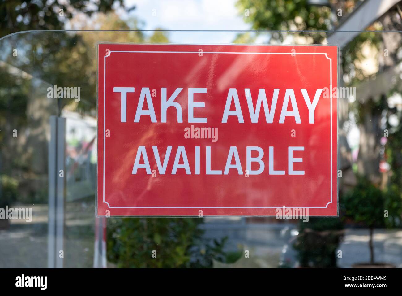 Take Away Available red signboard, text inscription on cafe business glass wall outside on street. COVID 19 pandemic lockdown, restaurants only to go Stock Photo