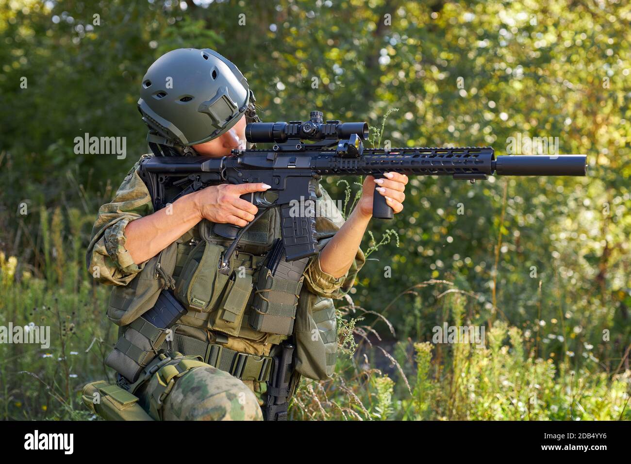 brave caucasian woman is engaged in hunting weapon gun or rifle ...