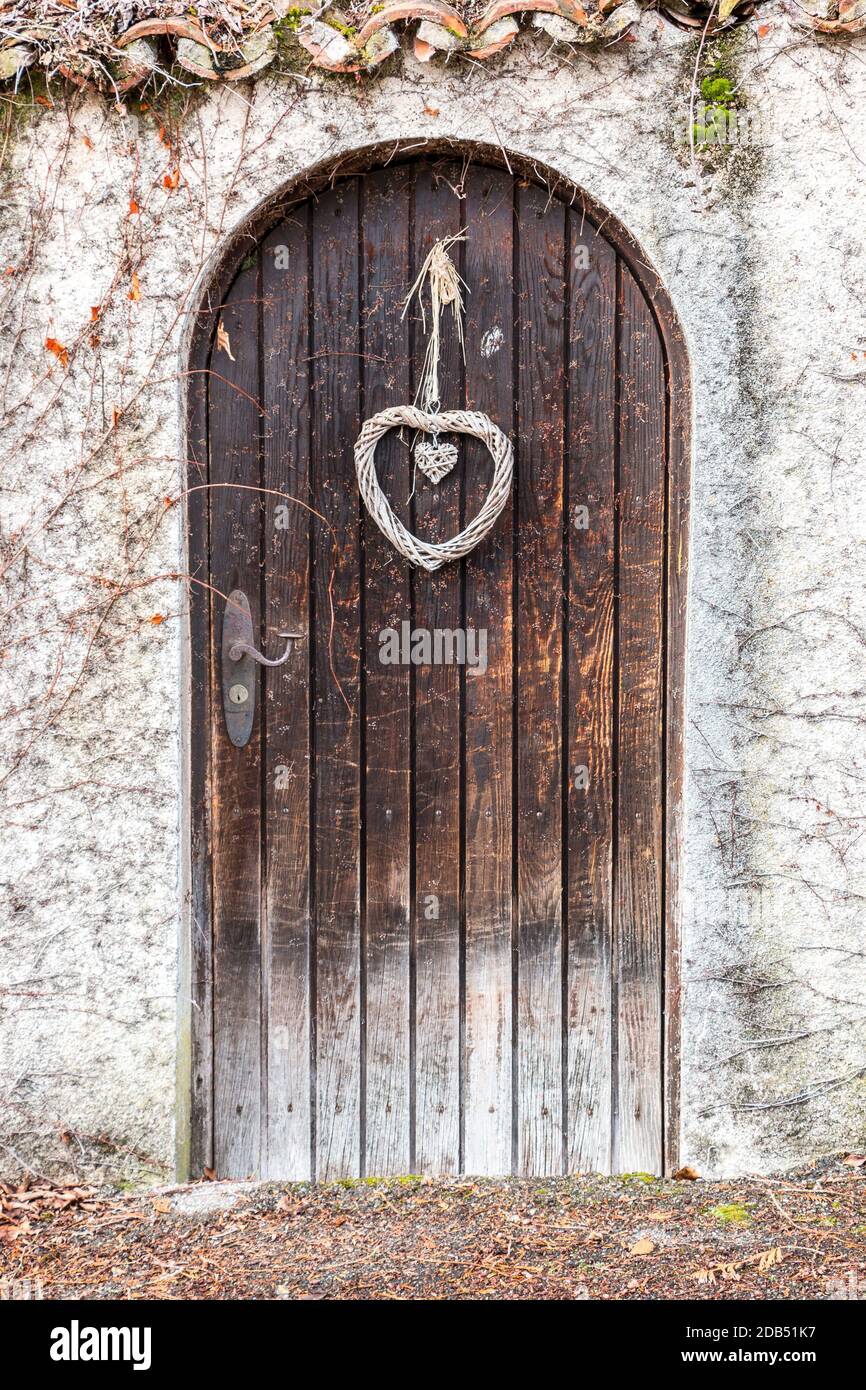 Old wooden door in a long stone wall Stock Photo - Alamy