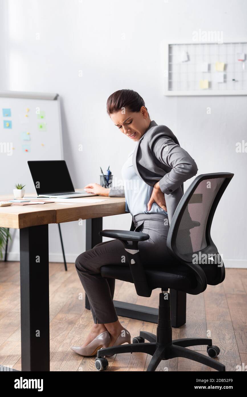Female back pose sitting in office hires stock photography and images