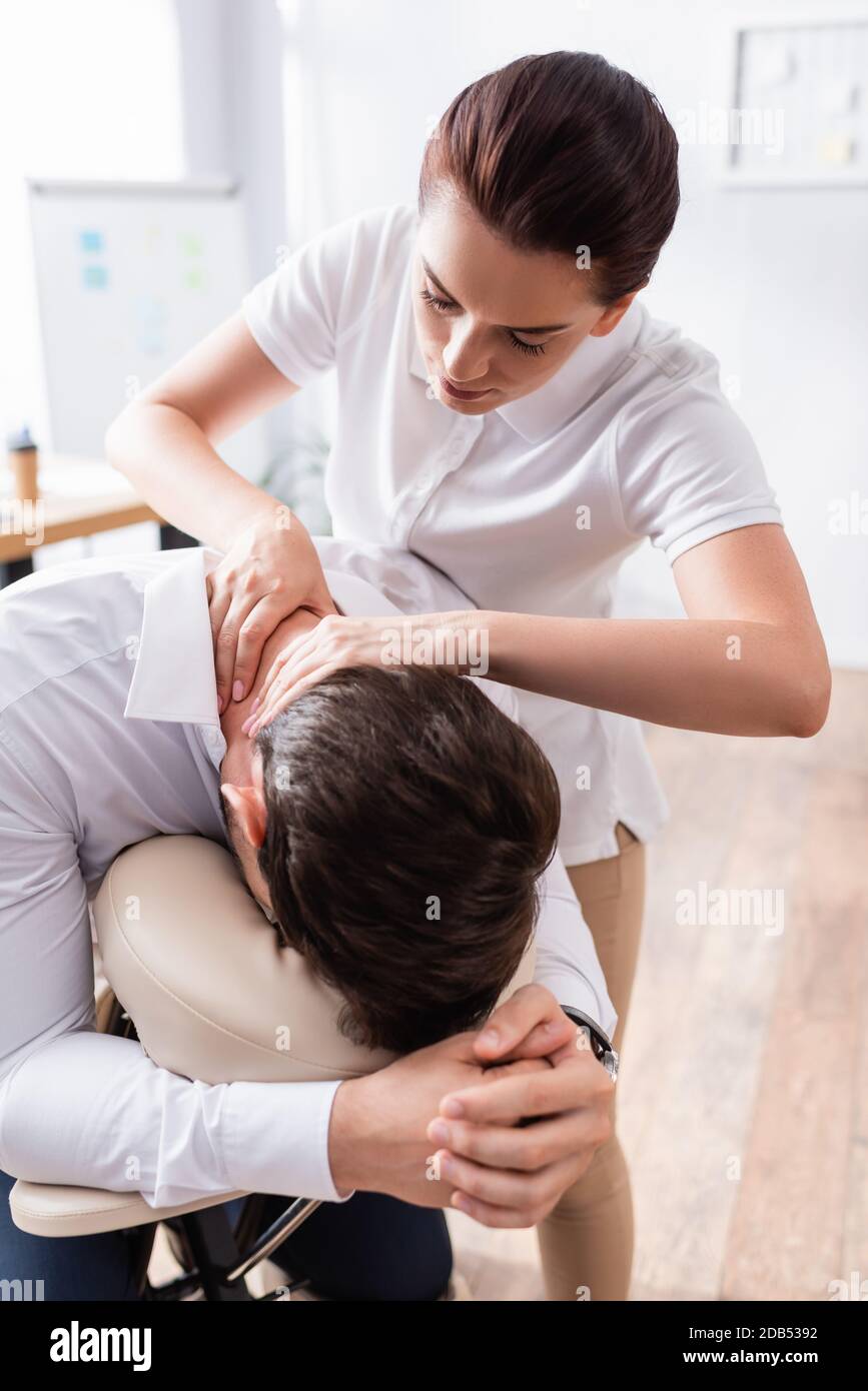 https://c8.alamy.com/comp/2DB5392/masseuse-doing-seated-massage-of-businessman-neck-in-office-on-blurred-background-2DB5392.jpg