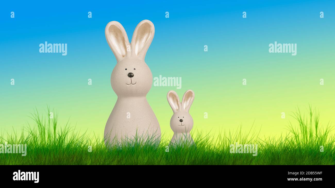 two easter bunnys stand on a meadow with pastel background Stock Photo