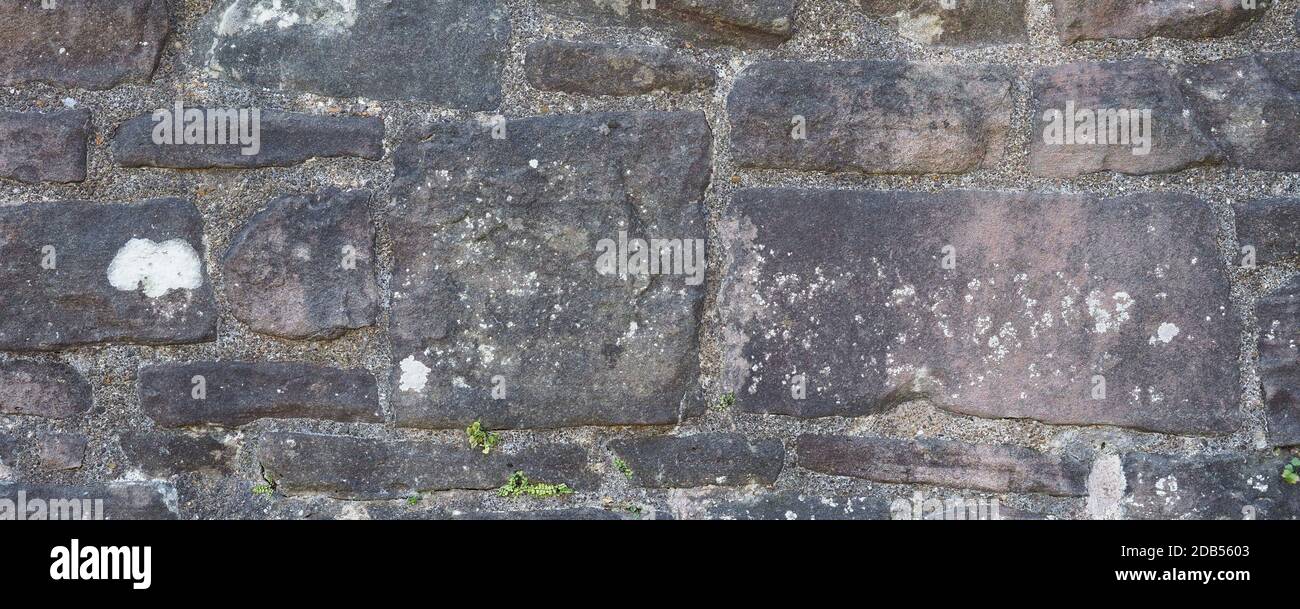 wide grey stone wall useful as a background Stock Photo - Alamy