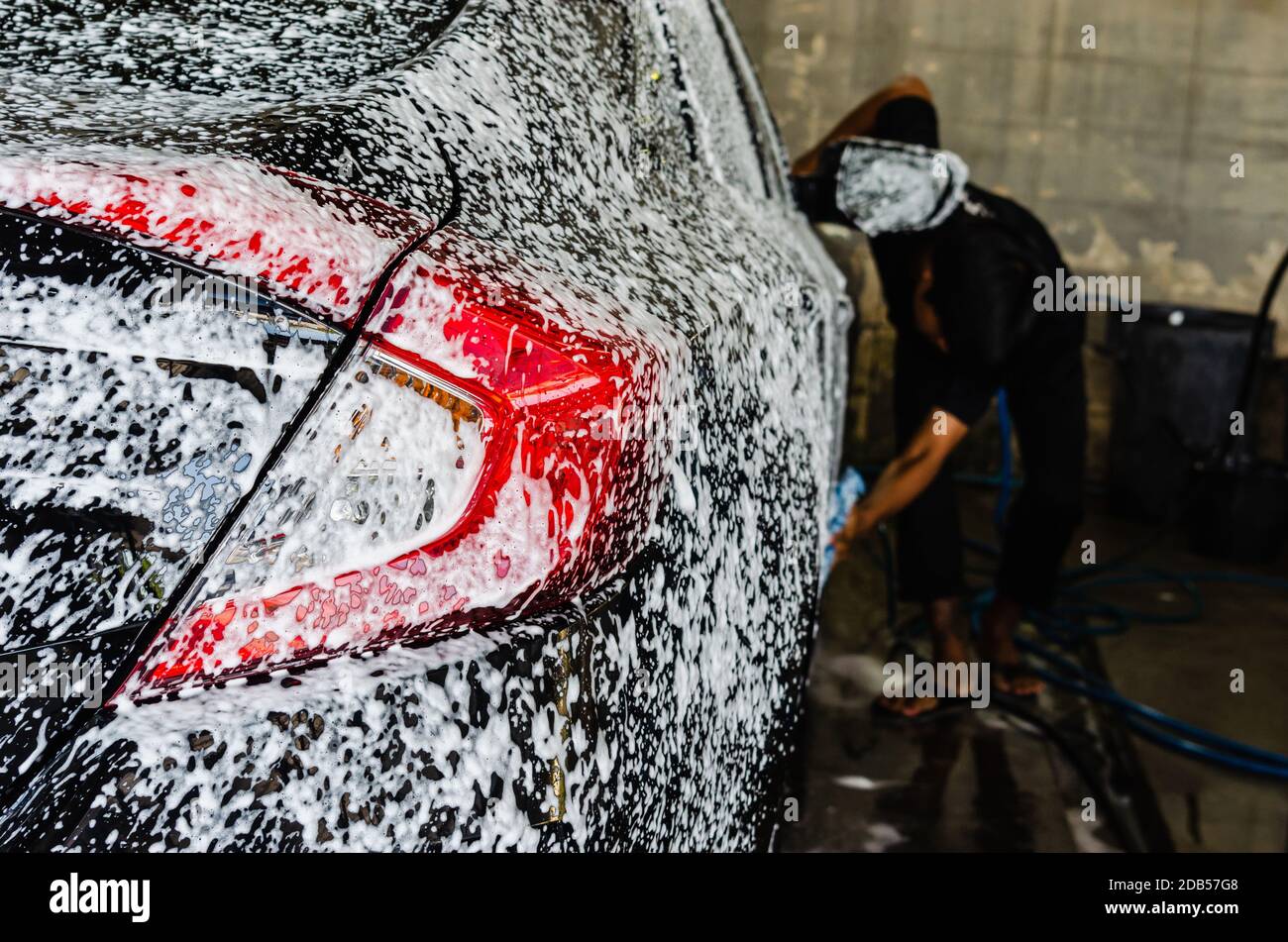Cleaning black cars. Wash the car at the car wash station with foam