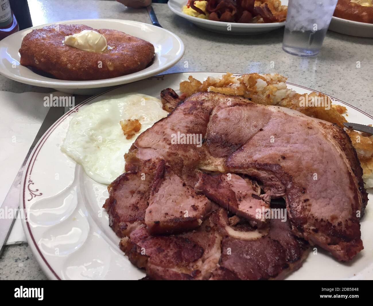 Ham and egg breakfast.  This traditional American breakfast is a staple in many restaurants. Stock Photo
