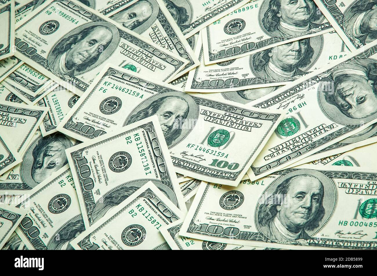 A pile of one hundred US banknotes with president portraits. Cash of hundred dollar bills, dollar background image. Stock Photo