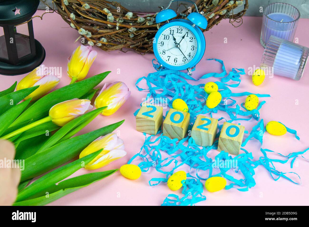 Word Easter on wooden cubes and surrounded with multiple egg decorations as a festive Easter background composition. Stock Photo