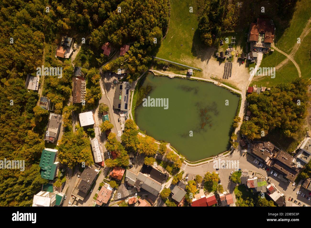 photo taken from above over the lake of cerretano in the resort of cerreto lakes at the foot of the ski slopes illuminated by the sun of an autumn aft Stock Photo