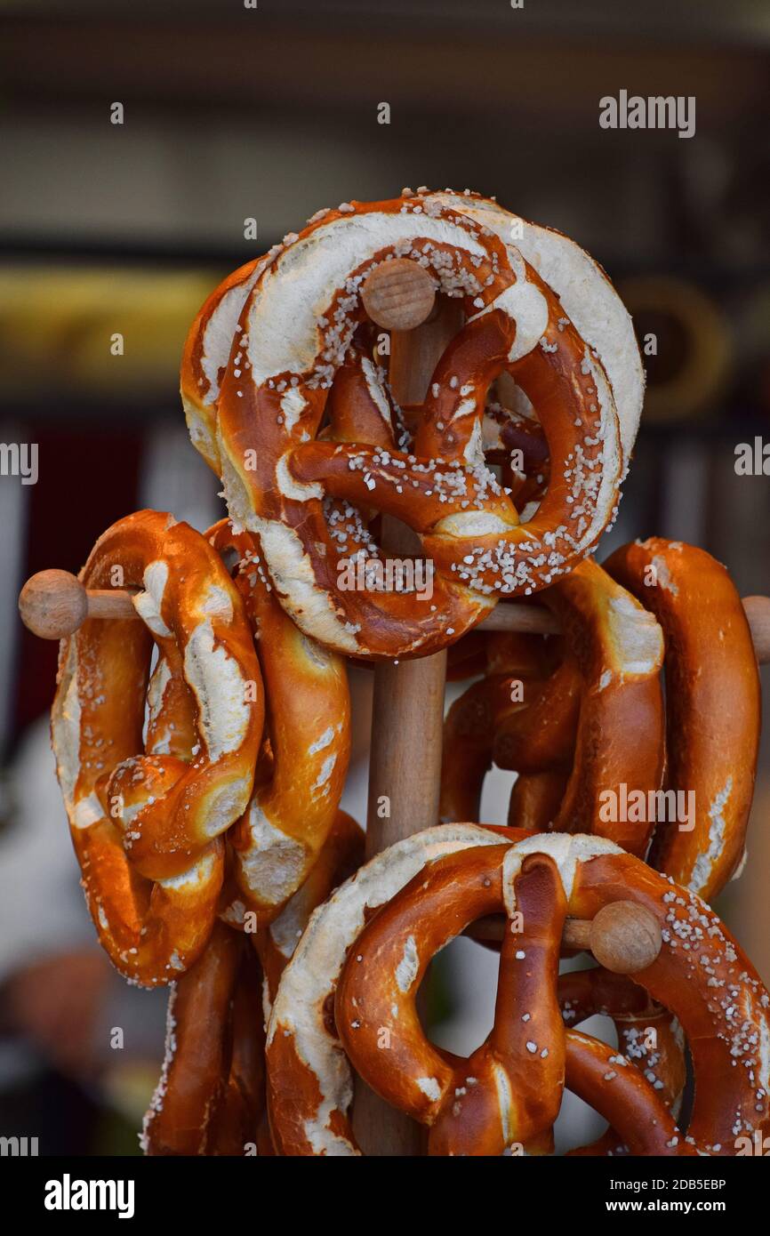 Close up several fresh traditional German pretzel bread knots hanging