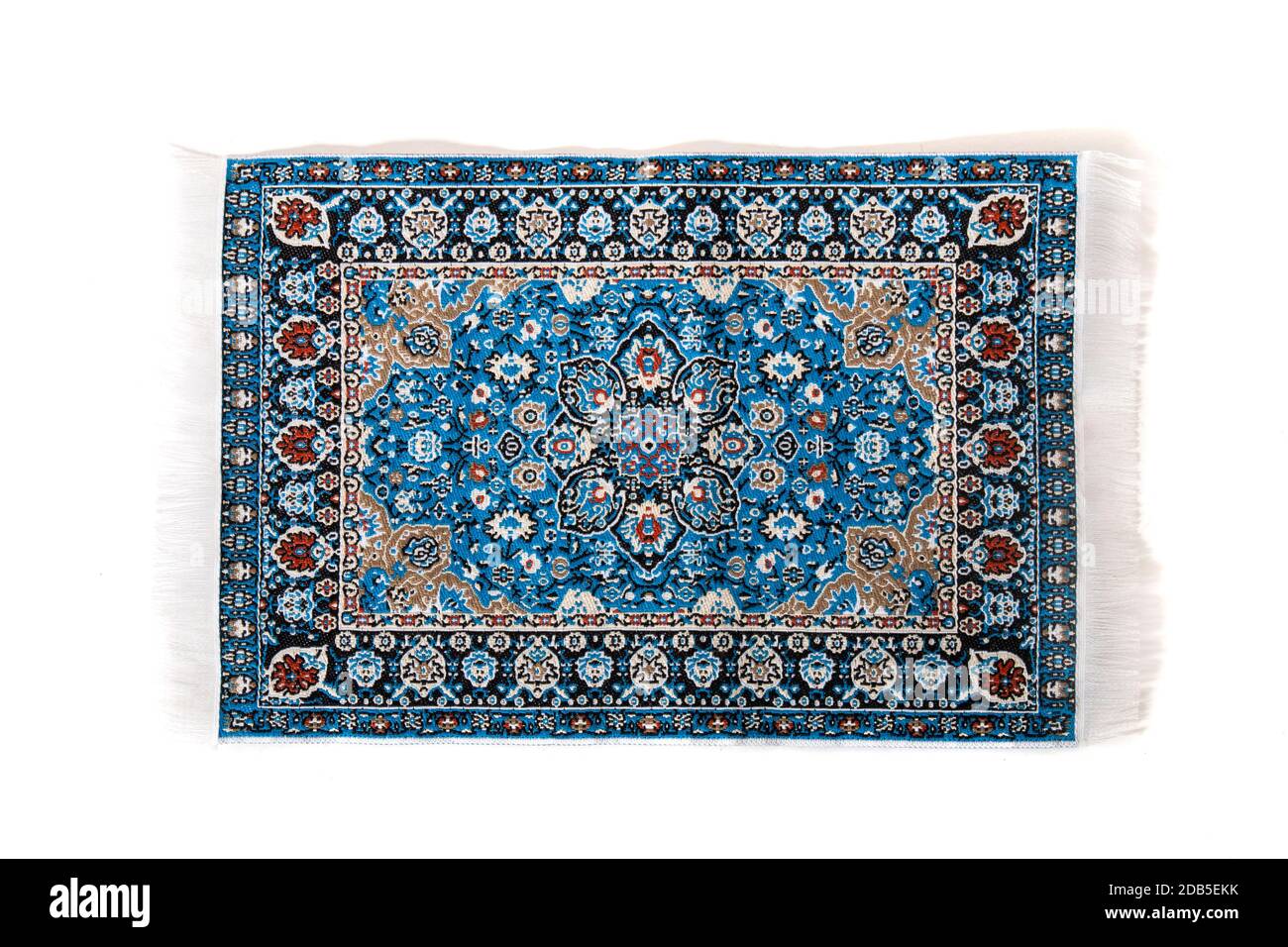 blue carpet with intricate design elements isolated on a white background. Stock Photo