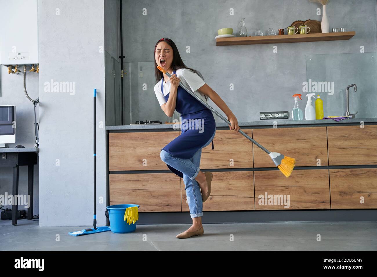 Full length shot of cheerful young woman, cleaning lady pretending to