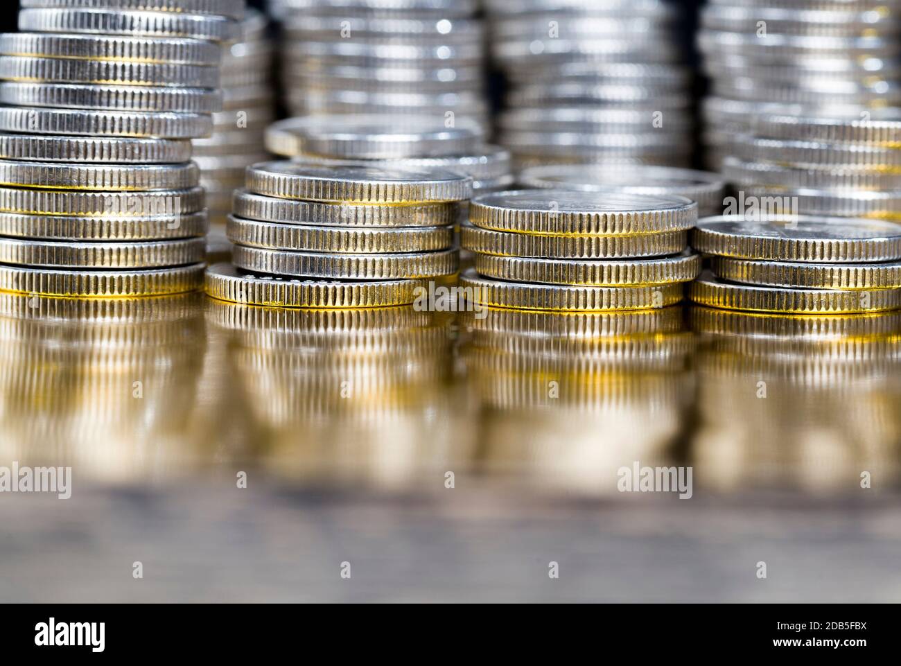 a large number of pile of silver coins with ribbed side, lie together, close-up photo of real metal money Stock Photo