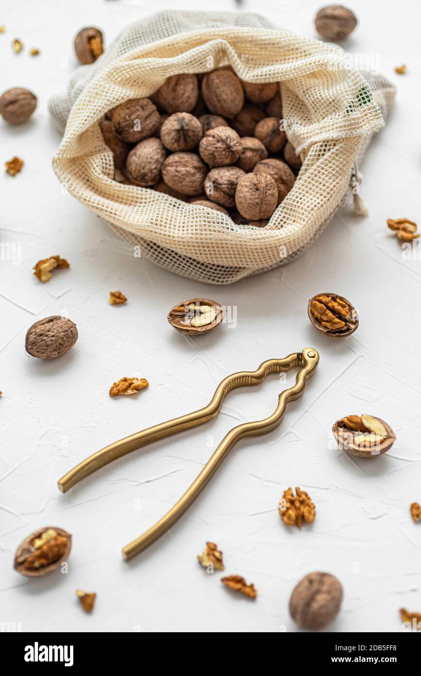 Walnut with nutcracker on white background Stock Photo