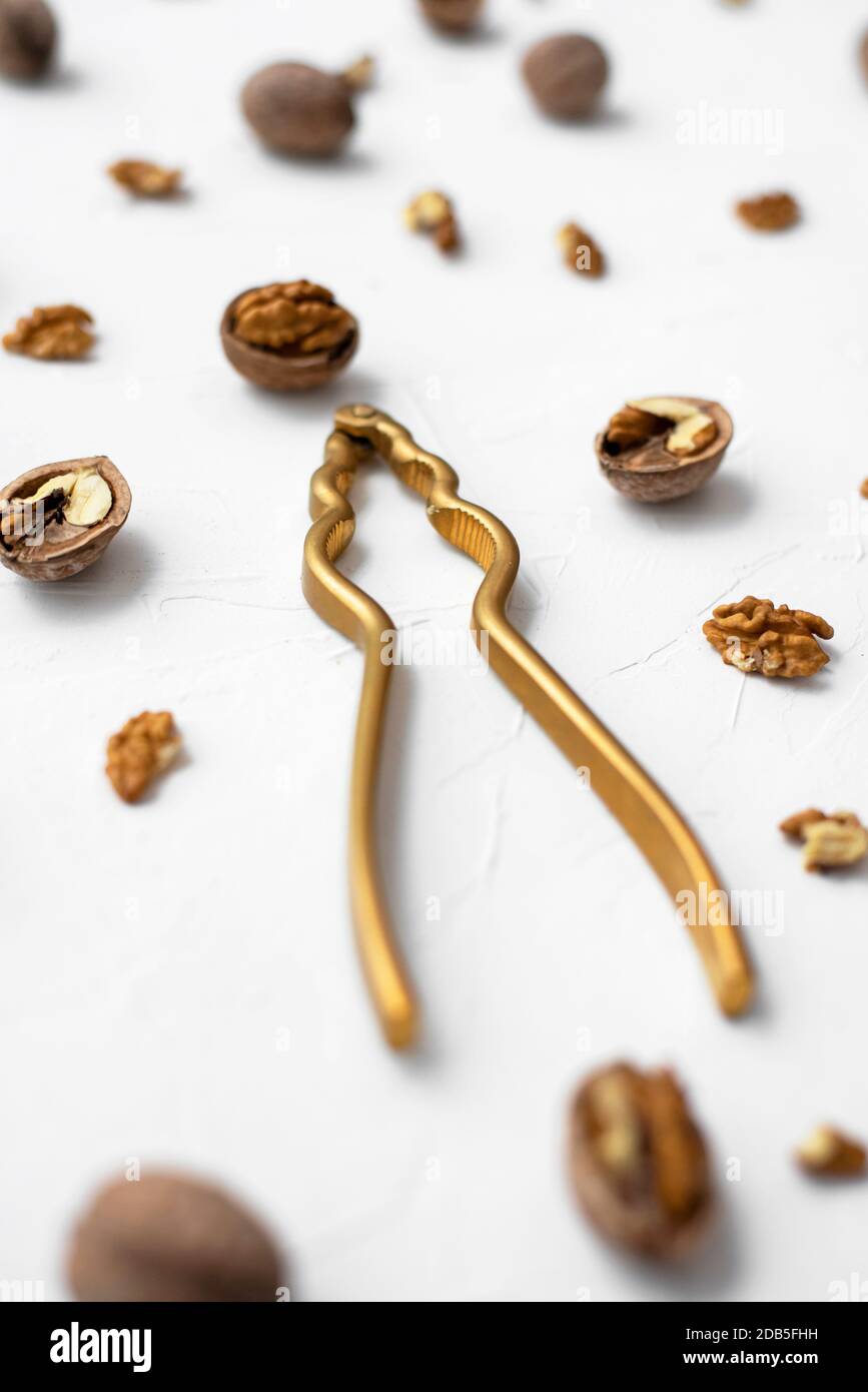Walnut with nutcracker on white background Stock Photo