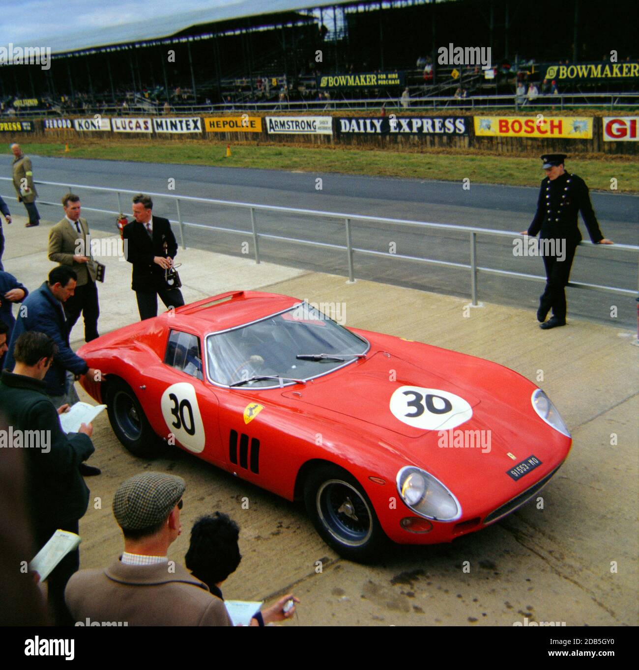 Graham Hill leaving the pits in his Ferrari 250 GTO at Silverstone Practise Day for the BRDC International Trophy meeting 1st May 1964 Stock Photo