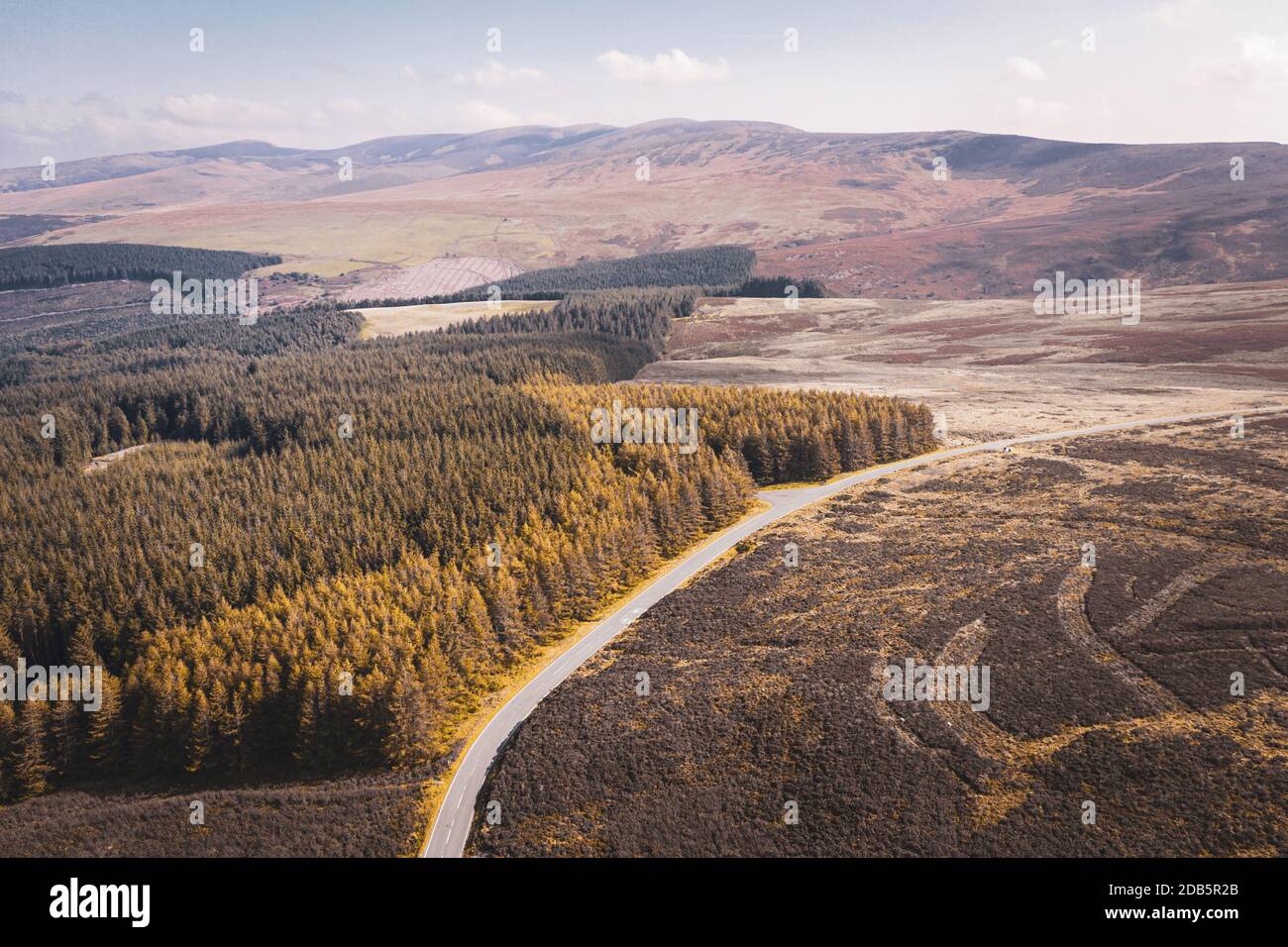 Drone view over scenic road across scenic landscape at bright autumnal day in Wales, United Kingdom Stock Photo