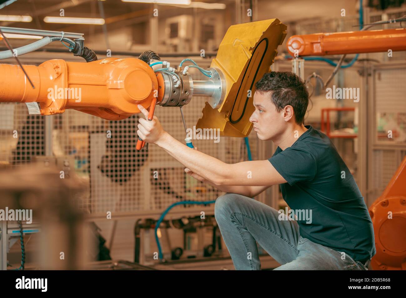 setting up a robotic line with automatic arms before starting the process. Stock Photo