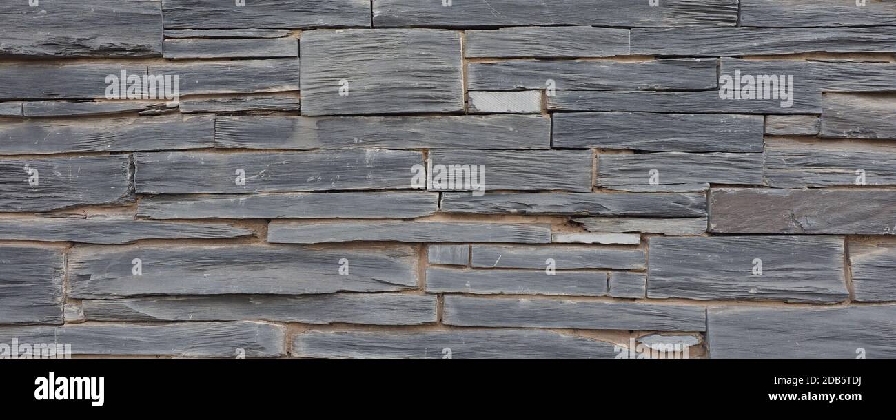 wide Grey stone wall useful as a background Stock Photo - Alamy