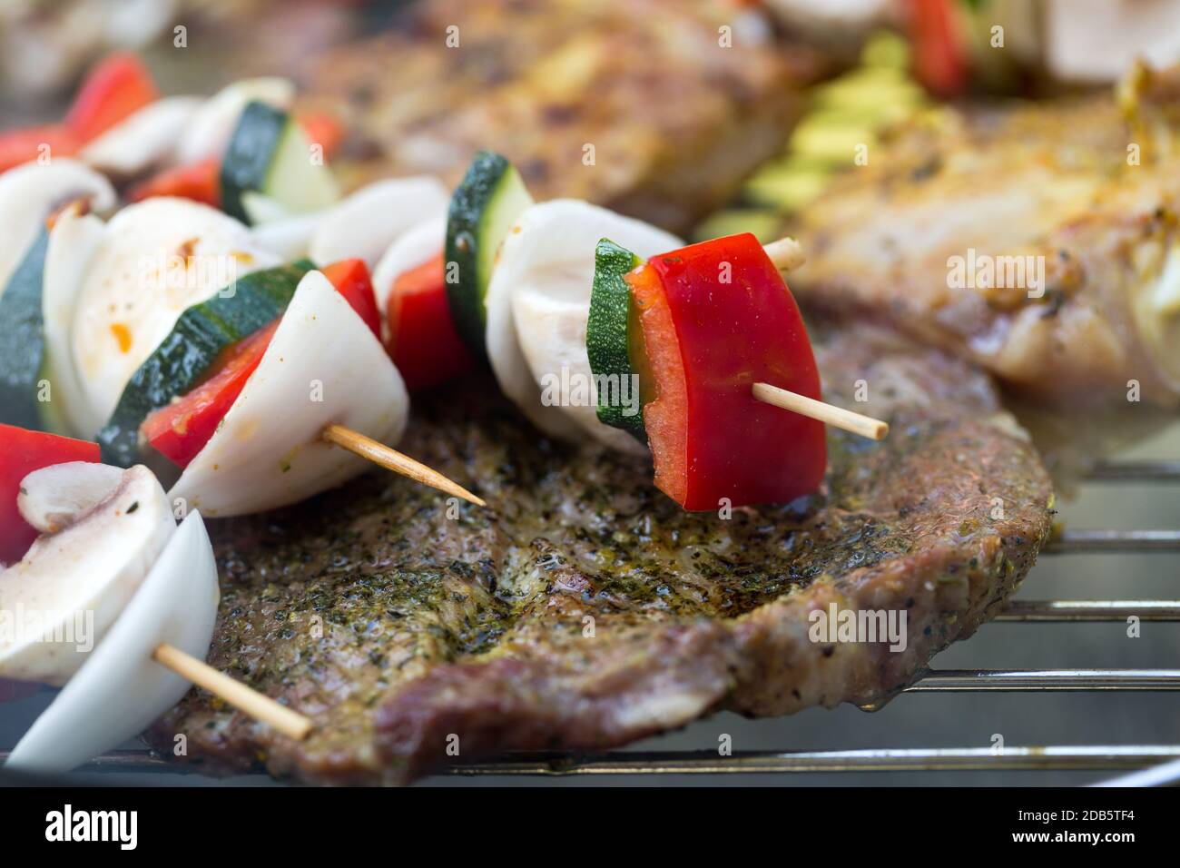 barbecue with delicious grilled meat and vegetables on grill Stock ...
