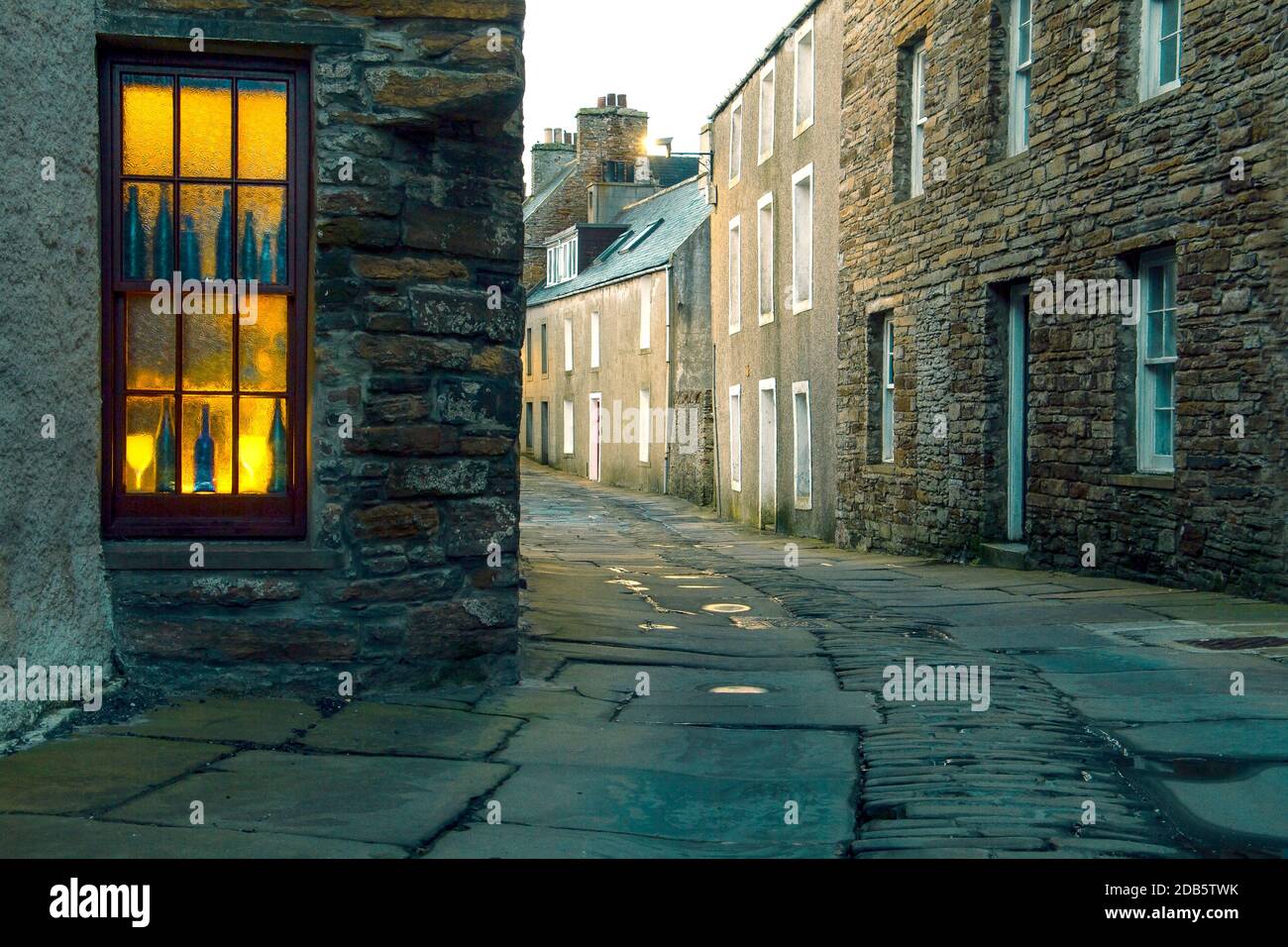 Romantic narrow street in scottish town Stromness on Orkney at evening Stock Photo