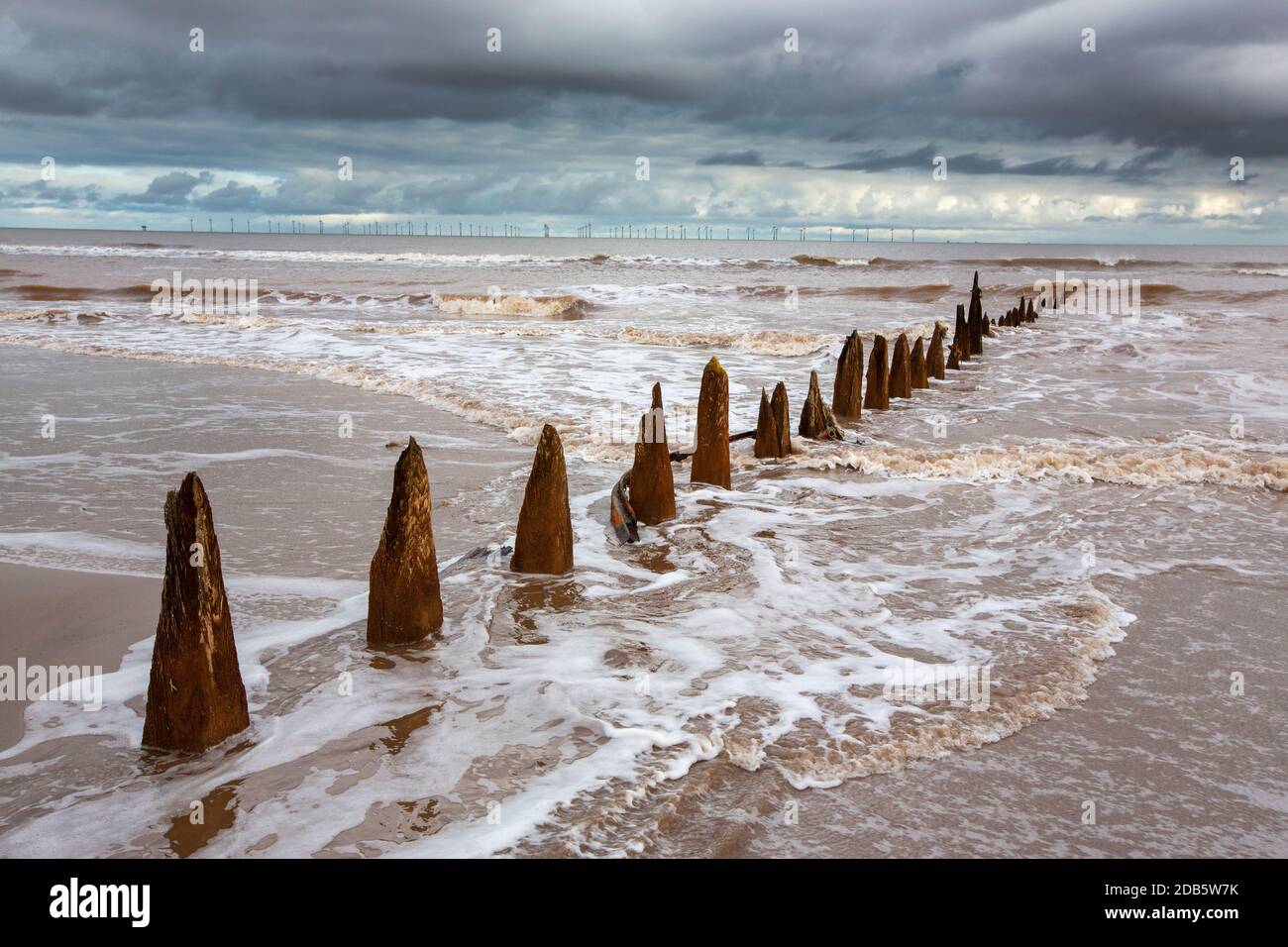 Coastal erosion breaking up old groyne sea defences on Spurn point on Yorkshires East Coast, UK. This section of coastline is the fastest eroding coas Stock Photo